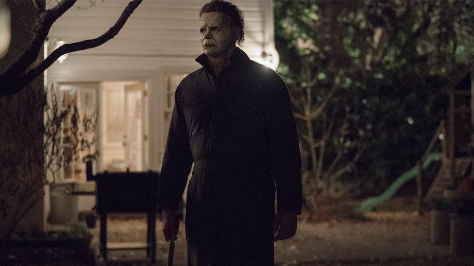 Michael Myers is pictured holding a long knife by his side