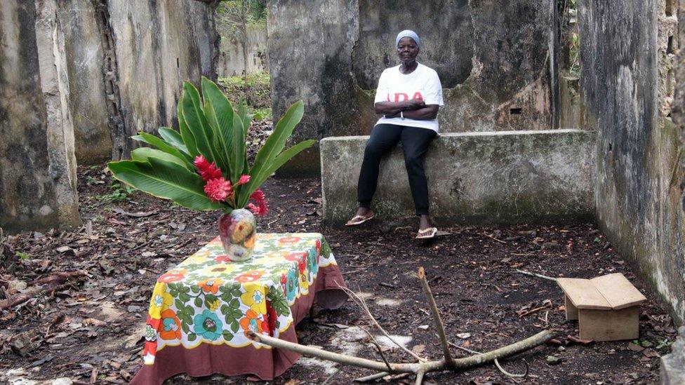 Ana Felicia Velaquez, who returned to the house she had been forced to flee during the war, bringing flowers so the house "would not feel sad"