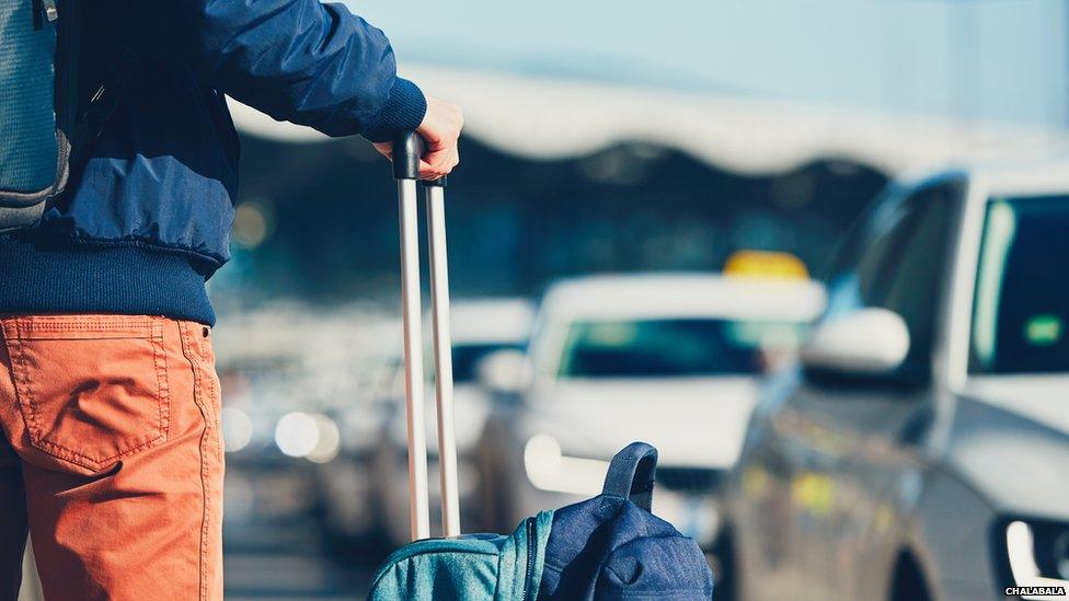 Passenger with suitcases at airport