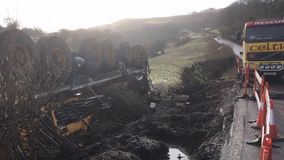 The crane has toppled over in a field