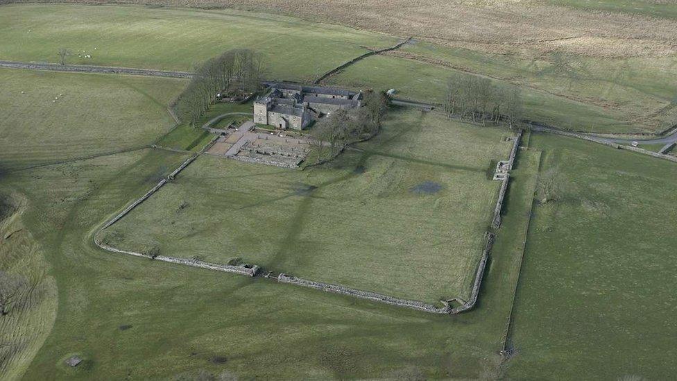 Aerial view of Roman fort, a large square of grass surrounded by walls