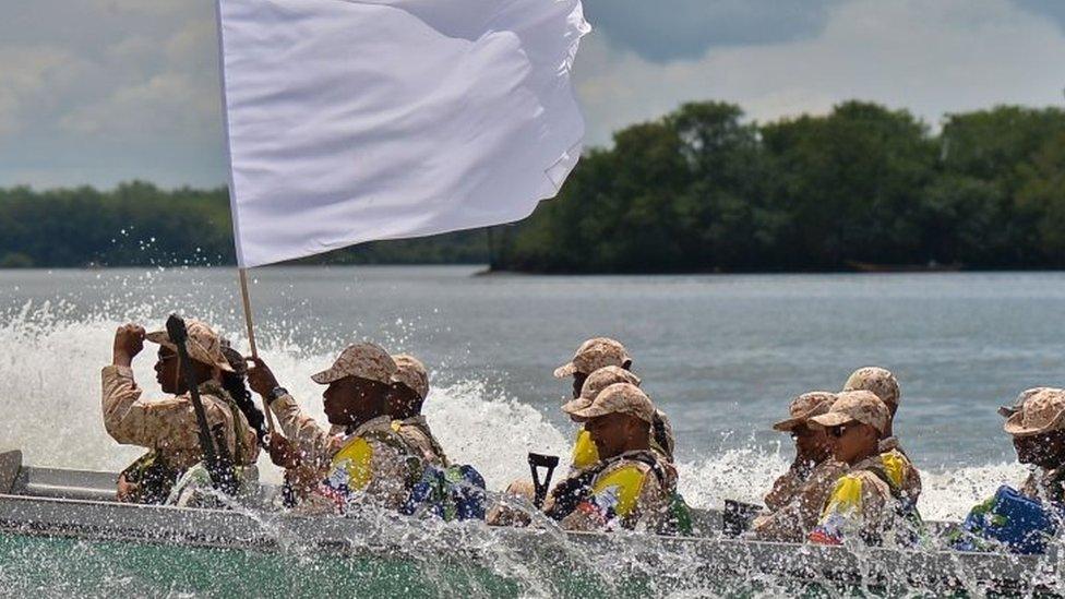 Members of the Farc guerrilla movement with a white flag arrive in Buenaventura, Colombia, on February 4, 2017