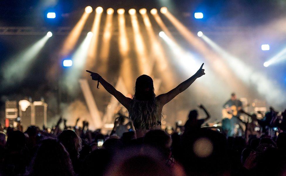 Fans watching a band at Download