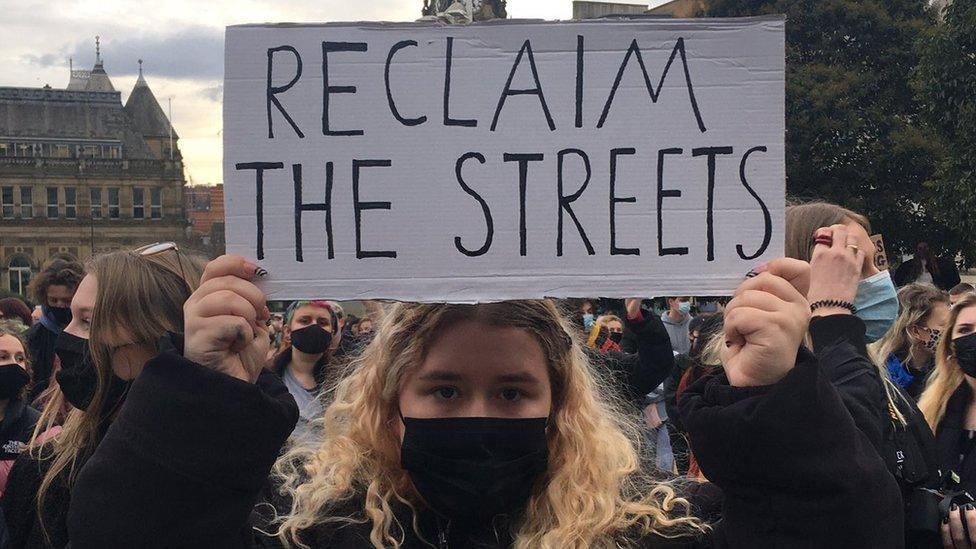 Woman holding a placard