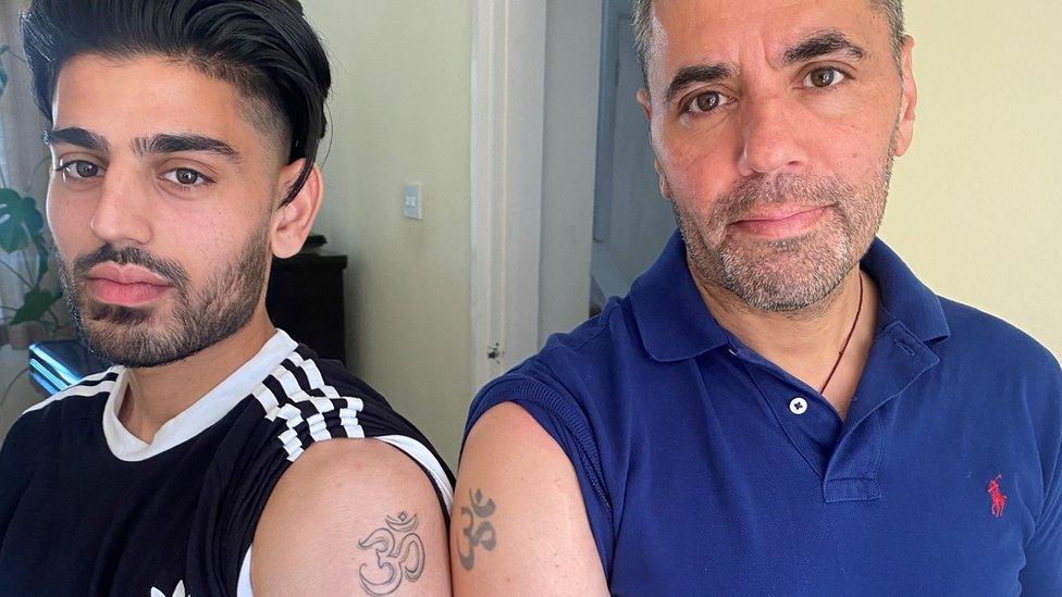 Vimal Korpal and his son who have matching tattoos of the Hindu symbol