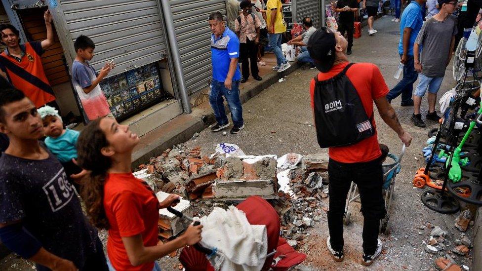 People in the street with debris