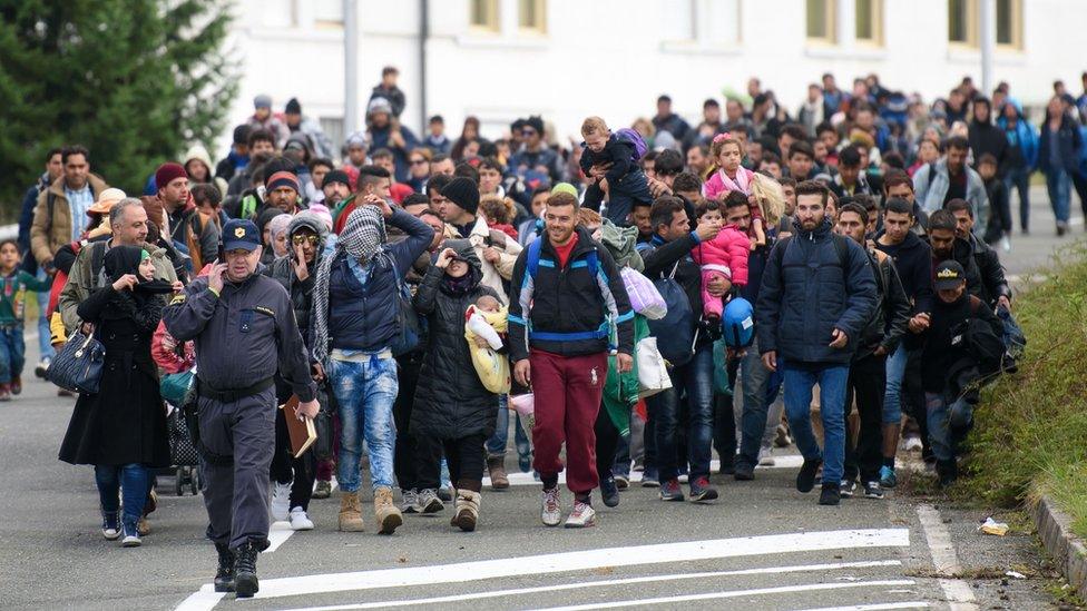 Migrants reach the Slovenian-Austrian border on 18 October 2015