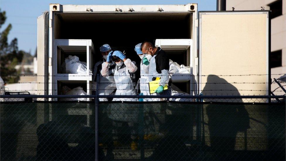 Inmates helping move bodies