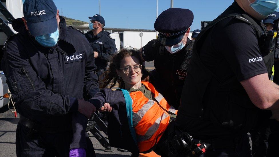 Police carry away a protester