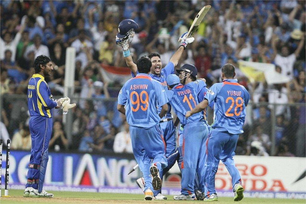 Sri Lanka's captain Kumar Sangakkara, left, looks on as India's captain Mahendra Singh Dhoni, center back, and Yuvraj Singh greeted by Ravichandran Ashwin, Piyush Chawla and Yusuf Pathan after winning the Cricket World Cup final match between Sri Lanka and India in Mumbai, India, Saturday, April 2, 2011.where they beat Sri lanka by Six Wickets.