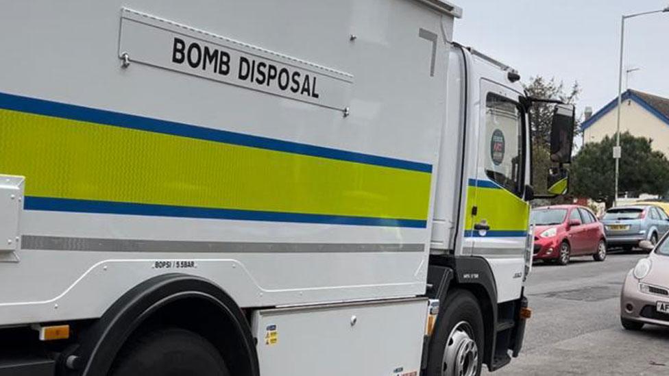 A bomb disposal van arriving in a street