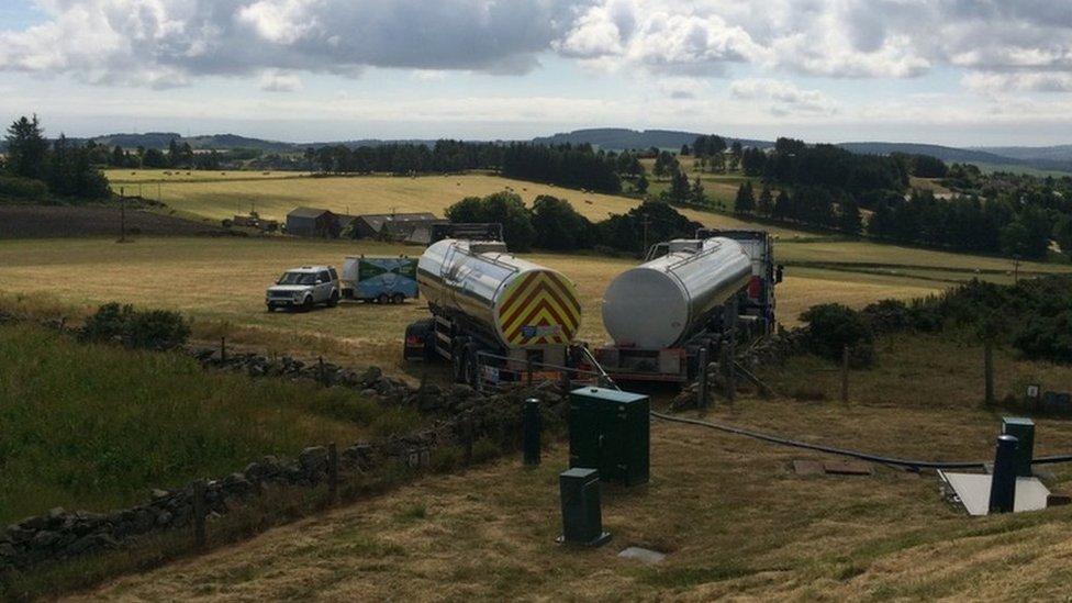 Tankers in a field