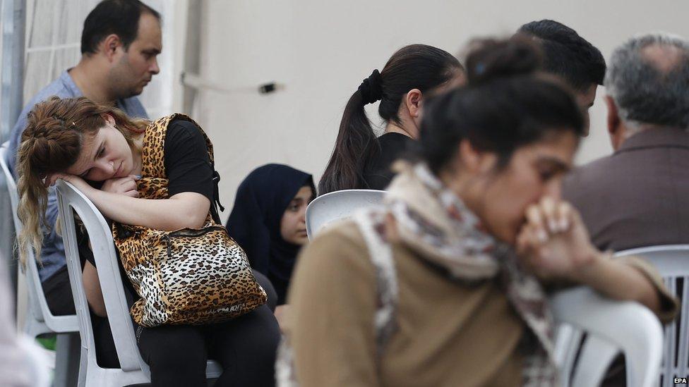 Relatives wait outside a morgue in Ankara, 11 October