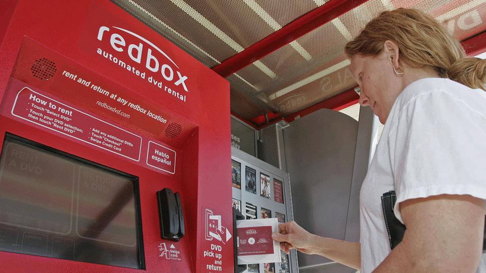 Woman using a Redbox booth