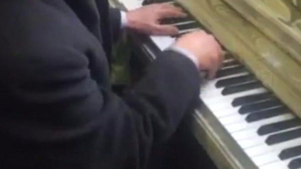 Man plays piano at Clapham Junction station