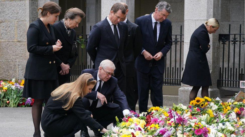 Members of the Royal Family read tributes left for the Queen.