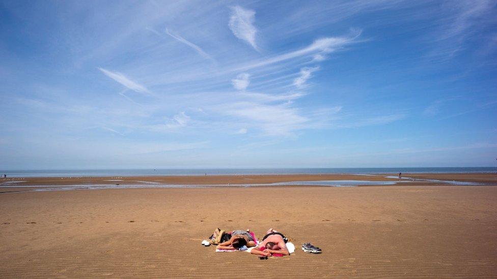 Holidaymakers enjoy the high temperatures on Blackpool beach on 19 June 2017