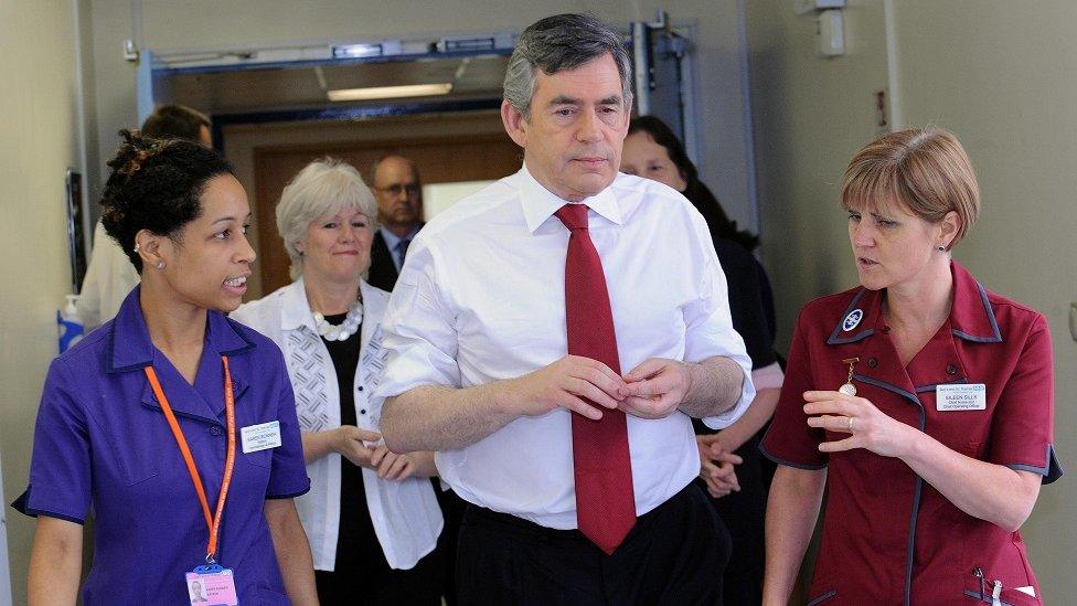 Gordon Brown with medical staff in a hospital