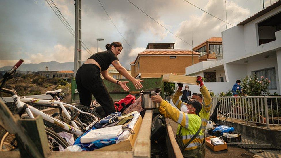 Officials help during an evacuation process