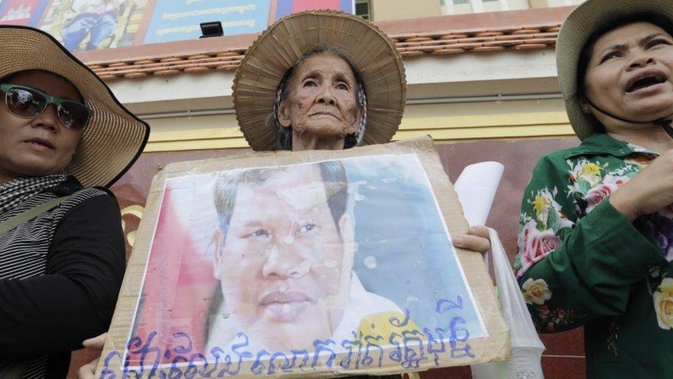 Protester holds a photo of Mony outside court