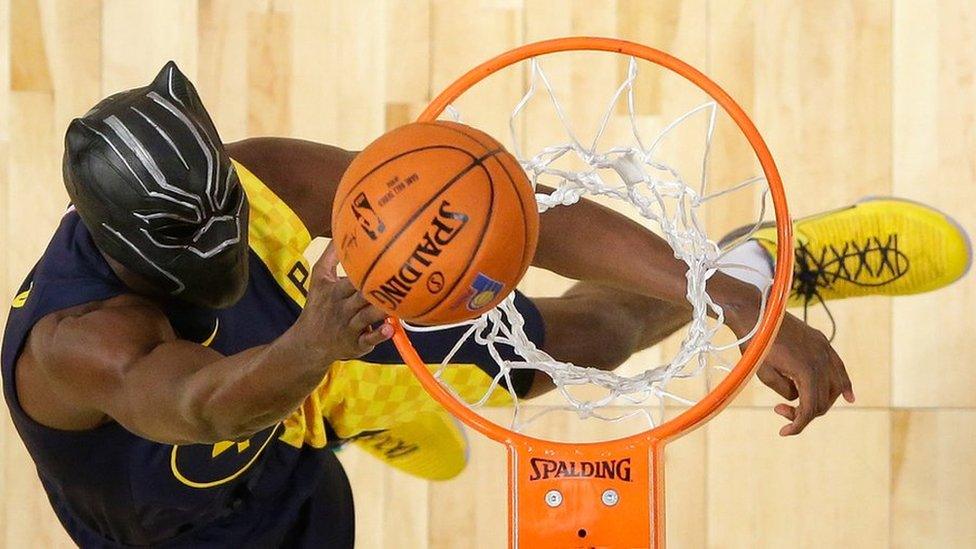 Victor Oladipo slam dunks in a Black Panther mask