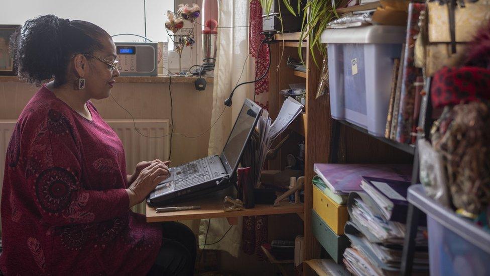 Ruby at her laptop, where she writes her poetry