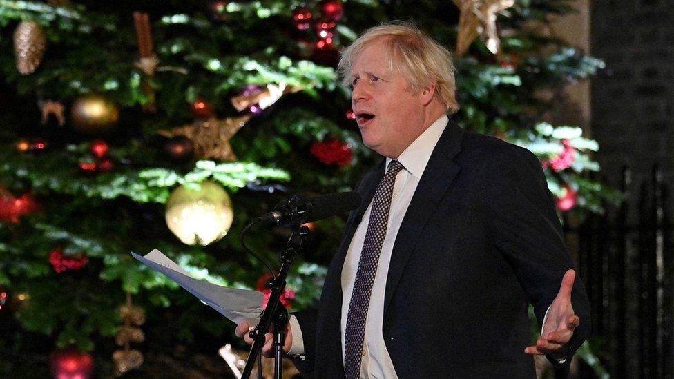 Boris Johnson giving a speech in front of the Downing Street Christmas tree