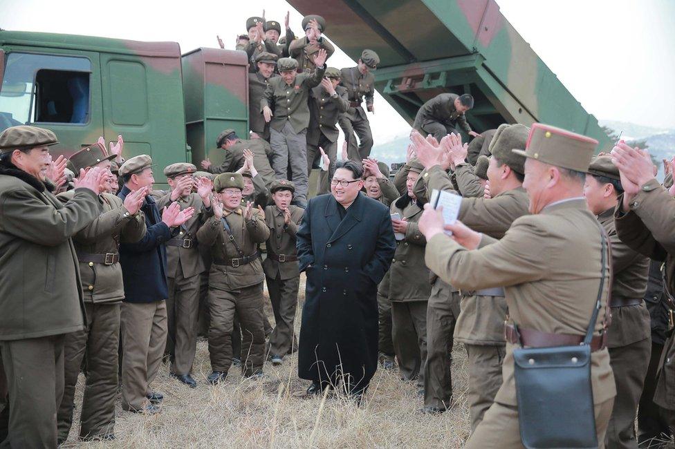 An undated photograph made available on 4 March 2016 by the North Korean news agency KCNA showing Kim Jong Un, supreme commander of the Korean People"s Army, meeting millitary personnel during the test-firing of new-type large-caliber multiple launch rocket system