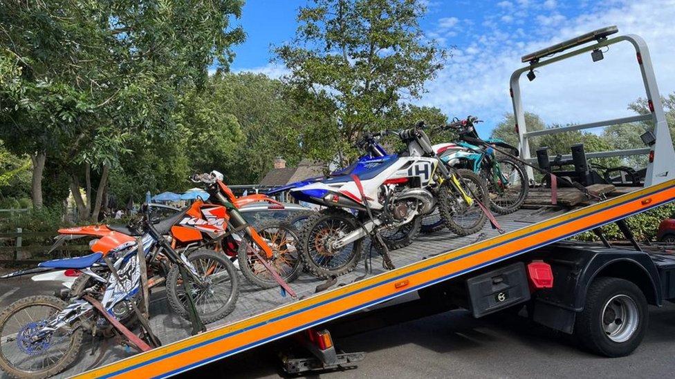 Six off road bikes sitting on the back of a truck