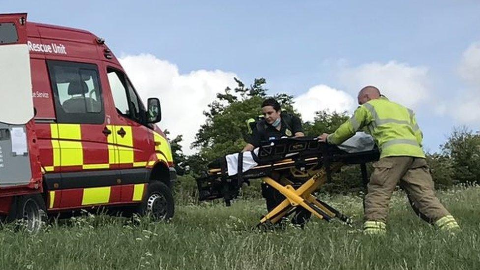 Emergency services rescuing paraglider