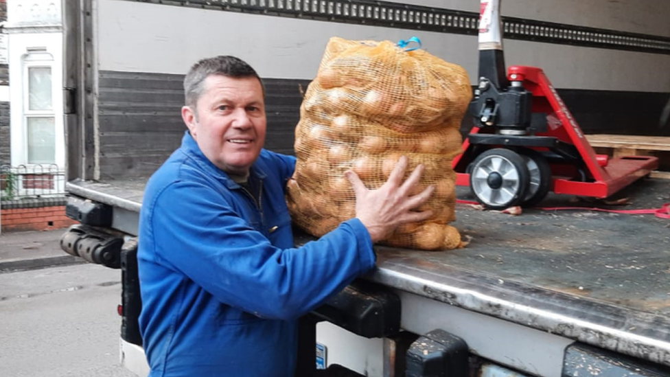 Patrick holding a bag of unions