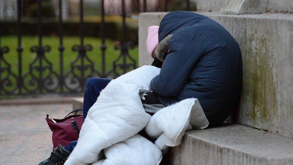 File photo of an anonymous rough sleeper sleeping in a doorway in London