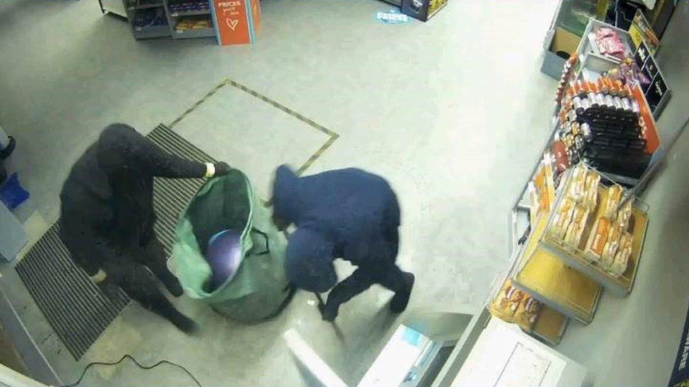 Burglars trying to open a cash machine