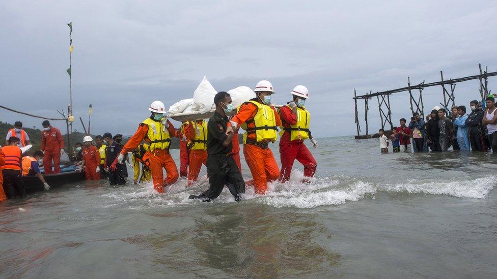 Myanmar rescuers recover a body from the plane crash in the Andaman Sea, on 8 June 2017