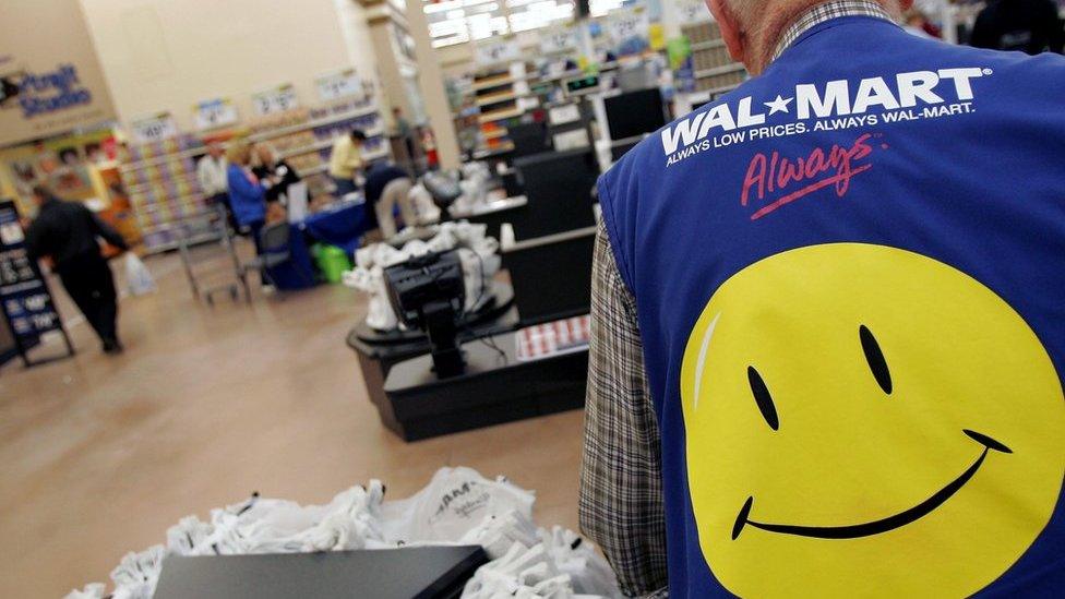 Wal-Mart employee with smiley face vest