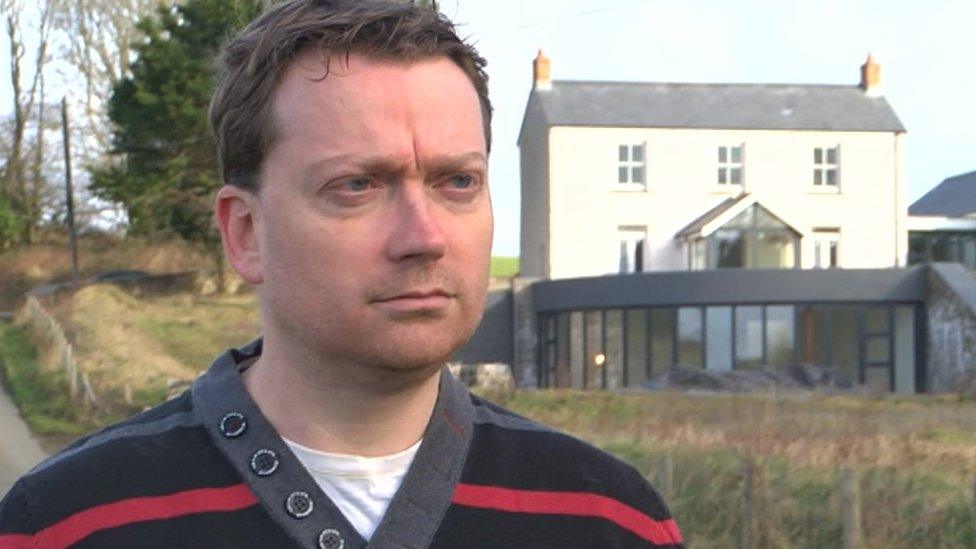 Photo of Mark Cole in front of the mine manager's house