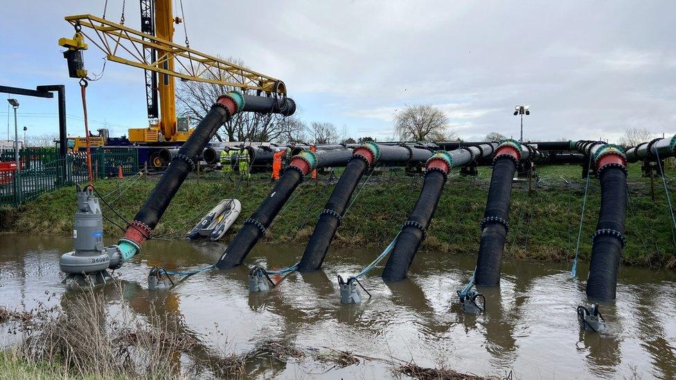 Pumps draining flood water