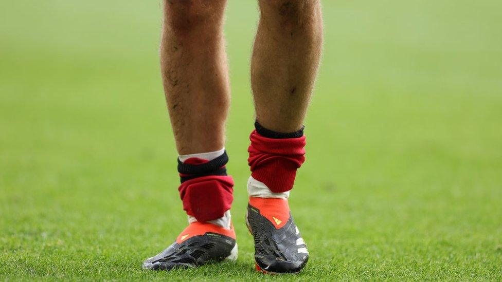 Player wearing mini shin pads