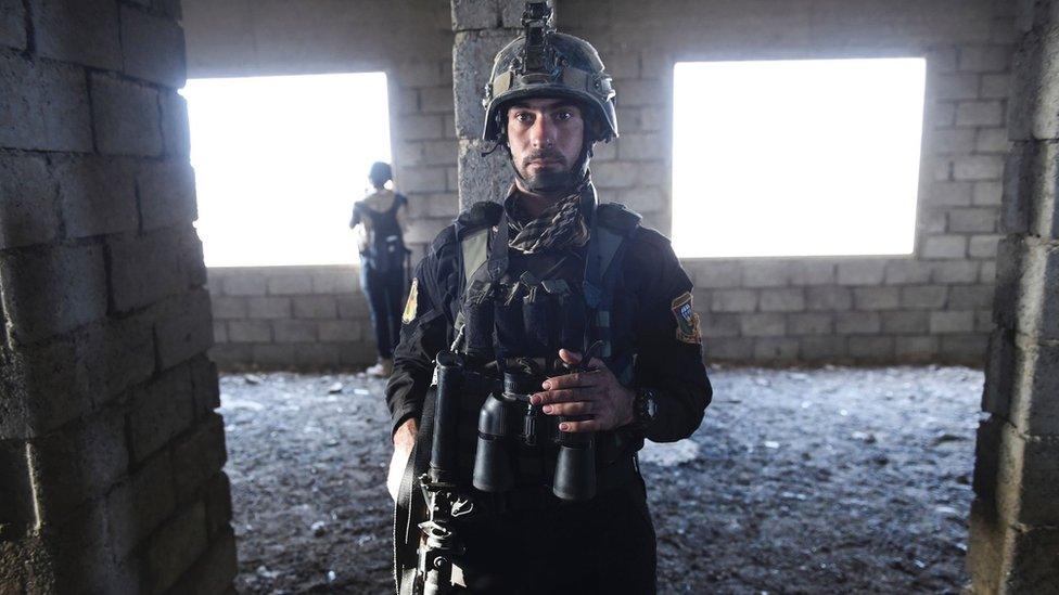 Iraqi Counter Terrorism Service (CTS) fighter stands during clashes with IS militants near Bazwaya on 31 October 2016