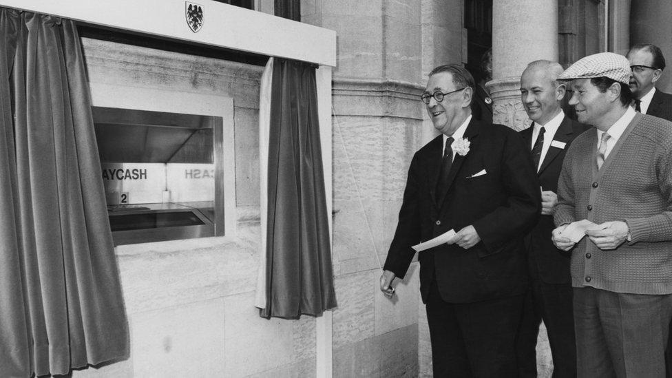 Sir Thomas Bland unveils the first Barclaycash machine alongside TV actor Reg Varney, in Enfield, north London