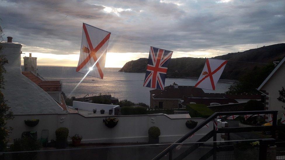 Jersey and Union flags hung