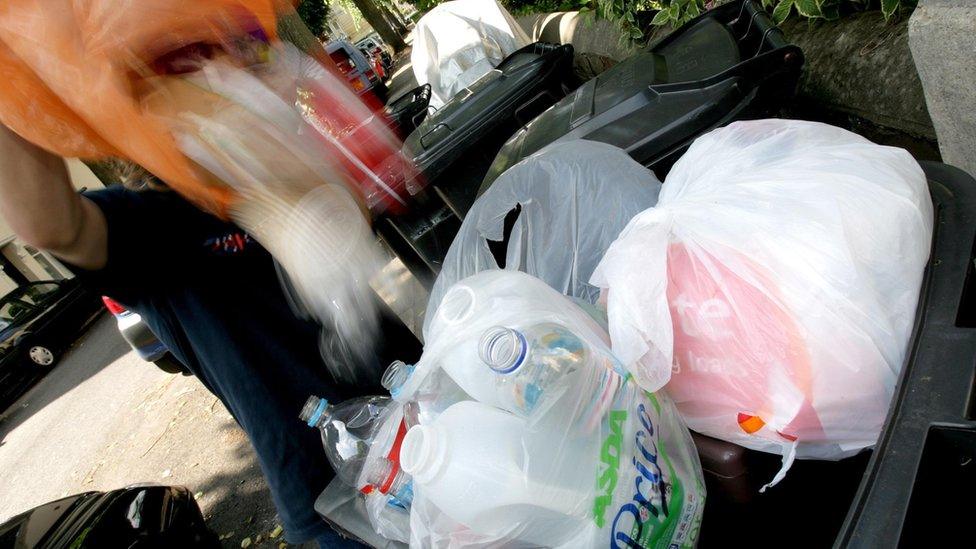 Waste being emptied into a wheelie bin