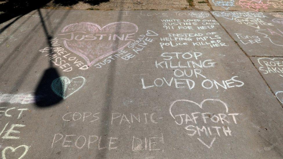 A makeshift memorial in the alley where Damond died