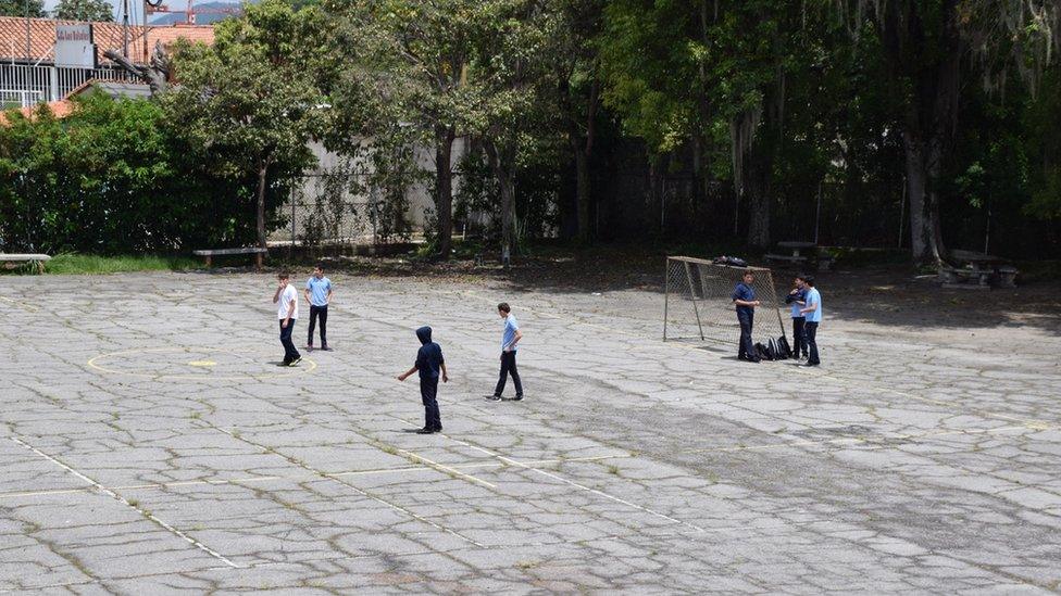 Pupils play football in the school yaard