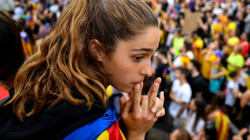 Protesters wave flags in the street as a general strike is called following a week of protests over the jail sentences given to separatist politicians by Spain’s Supreme Court, 18 October 2019