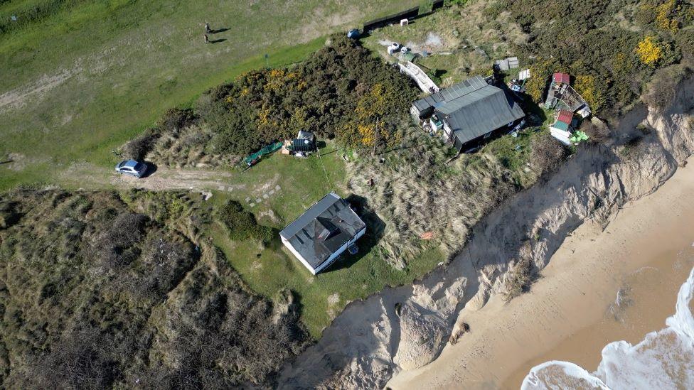 Drone picture shows two homes near the cliff edge at Hemsby beach