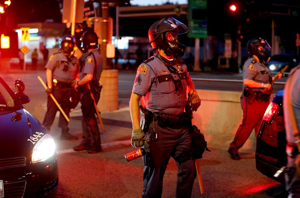 Police officers face protesters