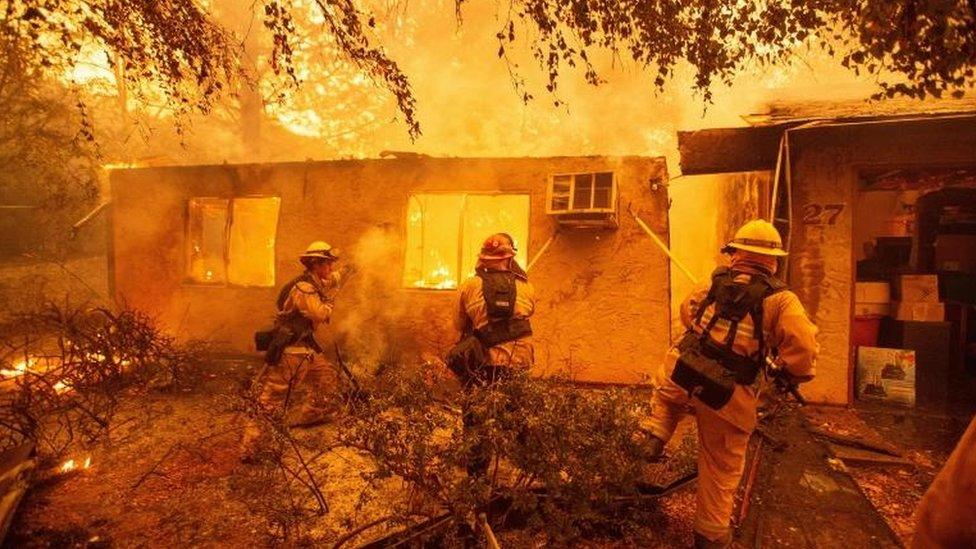 Firefighters tackle a fire in Paradise, California.