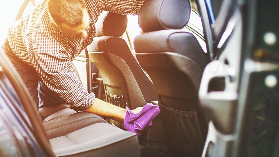 A man washing the inside of a car