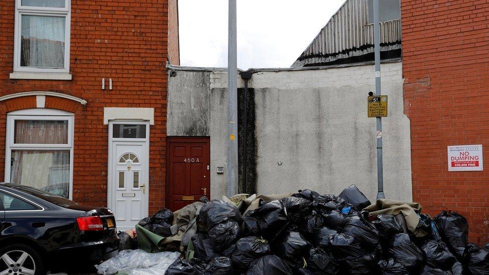 Rubbish piled up outside houses